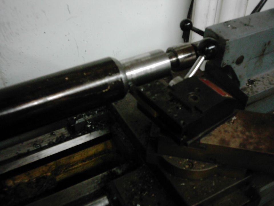 Metal shaft being machined on a lathe
