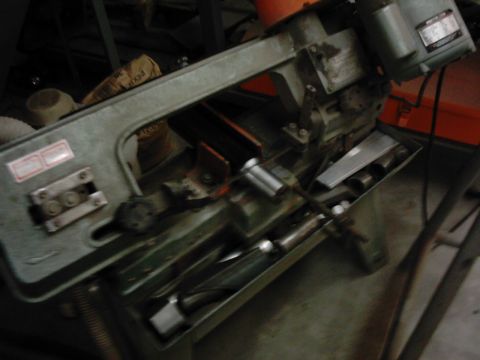 1978 Ford Bronco - A band saw is shown with various metal pieces in its collection tray.