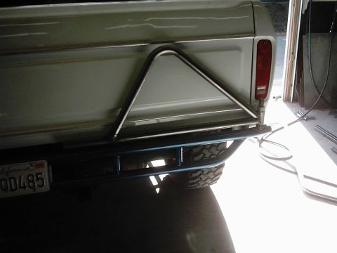 1978 Ford Bronco - Custom rear bumper and spare tire carrier assembly on a truck, seen from the back.