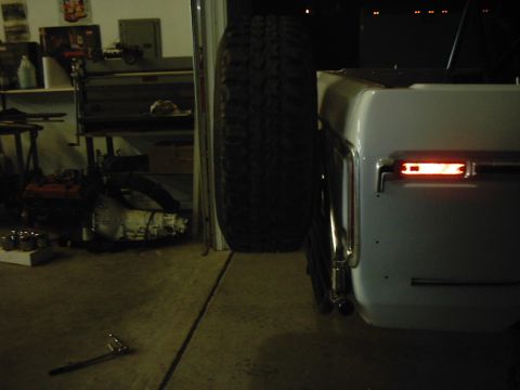 1978 Ford Bronco - Rear view of a 1978 Ford Bronco with an external spare tire carrier and visible taillight.