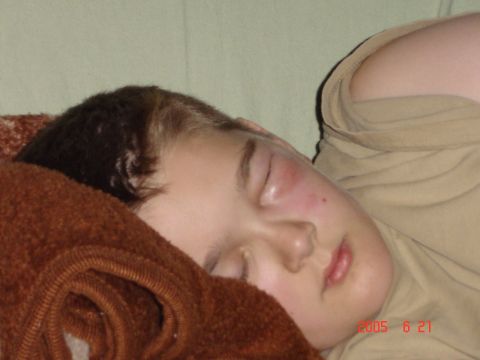 1993 Ford Bronco - A young child is asleep, resting on a textured brown blanket with a tan shirt visible.