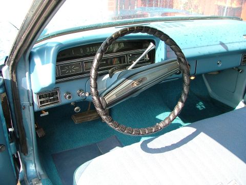 1970 Ford Ranchero - The interior of a classic car features a light blue dashboard and teal carpeting.