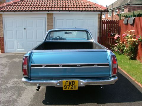 1970 Ford Ranchero - The rear of a blue 1970 Ford Ranchero is shown parked in front of a garage and garden.