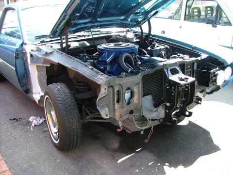 1970 Ford Ranchero - The front end of a blue 1970 Ford Ranchero is disassembled, revealing the engine bay.