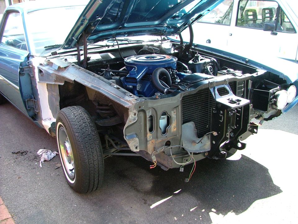Blue 1970 Ford Ranchero engine bay with hood open, front end disassembled