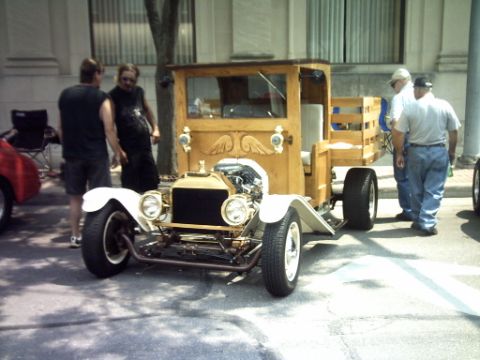 1995 Ford Probe - A custom-built hot rod truck with a wooden body and exposed engine is displayed outdoors.