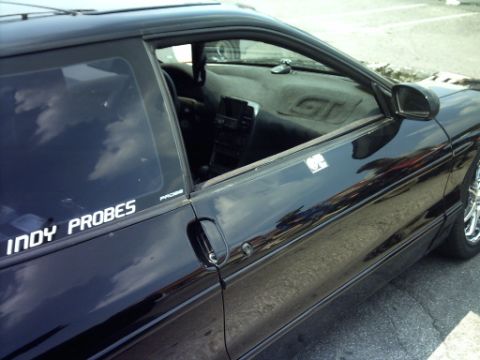 1995 Ford Probe - Interior view of a black 1995 Ford Probe, a sticker on the window.