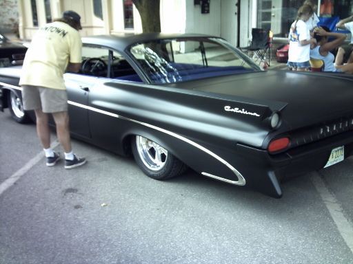 Black 1950s sedan with chrome trim and 'Catalina' badging, rear view