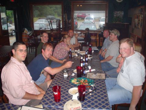 1981 Ford Bronco - People gather around a table in a restaurant, enjoying a meal and drinks together.