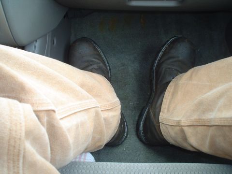 1981 Ford Bronco - View of the driver's feet and floor mat from inside the vehicle's cabin.