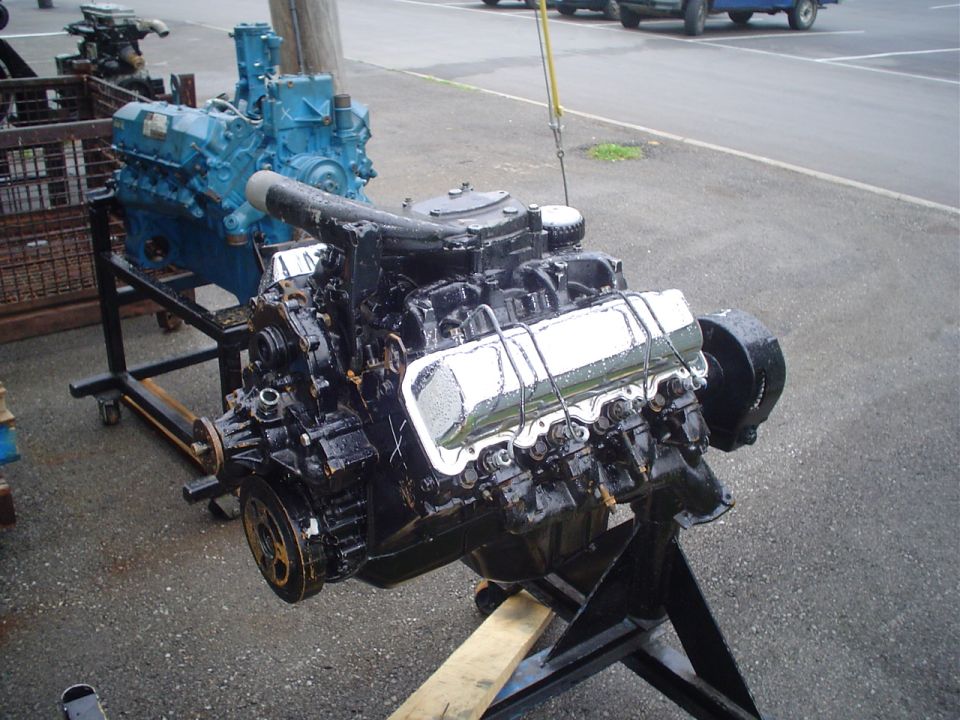 engine on stand, another blue engine behind it