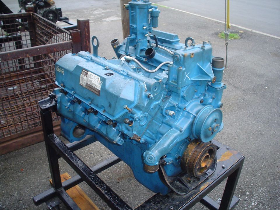 Blue engine on a stand, showing the front and side with a pulley system