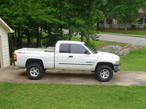 1981 Ford Bronco - A white pickup truck is parked on a driveway next to a garage.