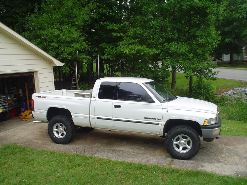 White pickup truck, side view, parked in driveway