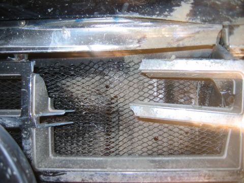 1985 Ford Bronco - Close-up of the 1985 Ford Bronco's front grille, showing the mesh and chrome accents.