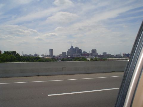1981 Ford Bronco - The photo shows a city skyline from the perspective of a vehicle on a highway.