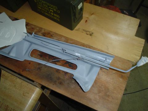 1981 Ford Bronco - Interior trim piece with attached cables, likely for a car door or window mechanism.