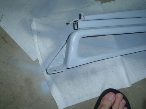 1981 Ford Bronco - A white car part is laid out on paper towels, possibly for cleaning or painting.