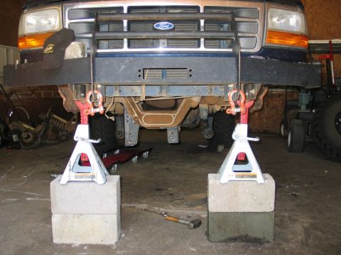 1995 Ford Bronco - Front view of a 1995 Ford Bronco being supported by jack stands in a garage.