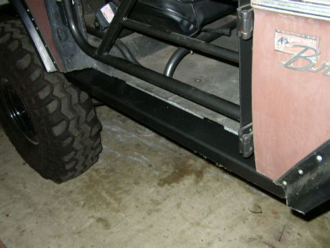 1995 Ford Bronco - Close-up of the side of a modified 1995 Ford Bronco, showing the door and a off-road tire.