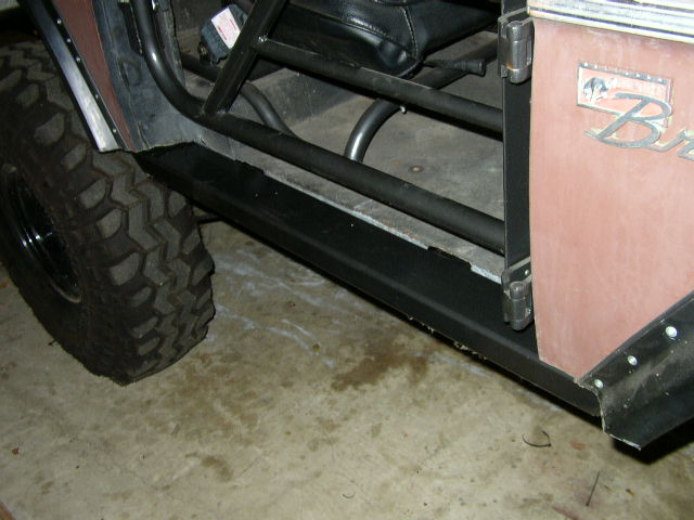 Side view of a 1995 Ford Bronco door with 'Bronco' badge and large off-road tire