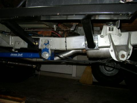 1995 Ford Bronco - The underside of a vehicle is visible, suspension components and exhaust systems.