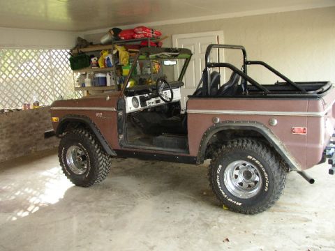 1995 Ford Bronco - This classic SUV, likely a 1975 Ford Bronco, is shown with its doors removed and a roll cage installed.