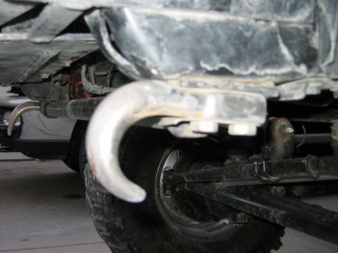 1985 Ford Bronco - Undercarriage view of a vehicle's tow hook and suspension system.