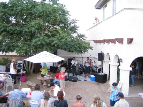 1968 Ford Mustang - A band plays music for guests at an outdoor party, with a tree and building in the background.