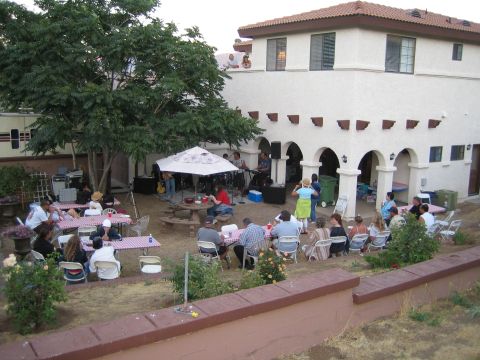 1968 Ford Mustang - An outdoor party is in full swing with guests enjoying food and music in a backyard setting.