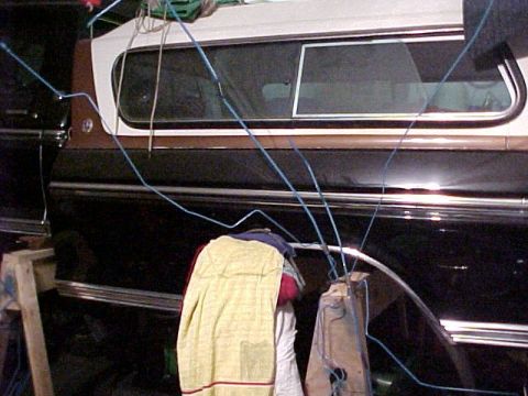 1979 Ford F-250 - The side profile of a 1979 Ford F-250 pickup truck with a camper shell is visible.