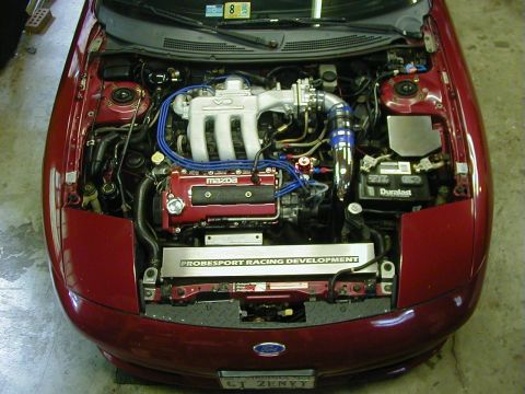 1994 Ford Probe - The engine bay of a 1994 Ford Probe shows a modified engine with custom racing parts.