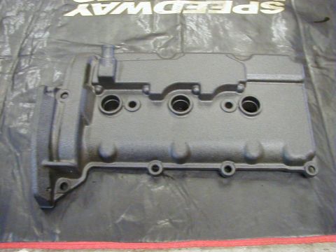 1994 Ford Probe - A black engine valve cover is shown from above, placed on a black cloth with visible text.