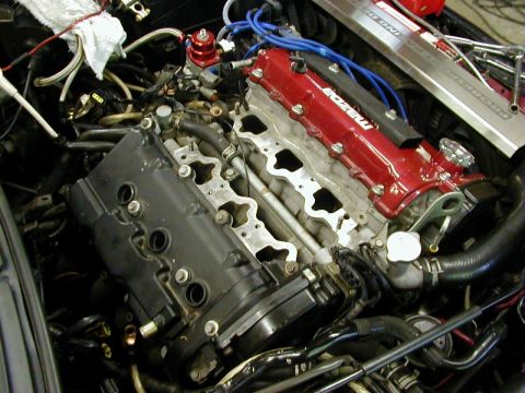1994 Ford Probe - The engine bay shows a Mazda engine with various hoses and wiring connected.