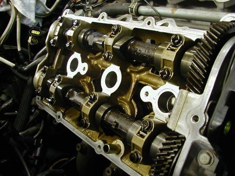 1994 Ford Probe - Close-up view of an engine's internal components, including camshafts and gears, with 'SUPERMOTORS' visible.