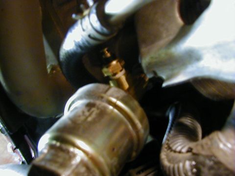 1994 Ford Probe - A close-up view of a brass sensor attached to an engine component, likely part of the cooling system.