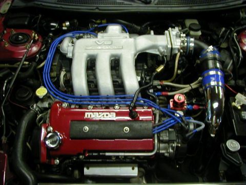 1994 Ford Probe - Close-up view of a modified Mazda V6 engine, showing custom intake and fuel lines.