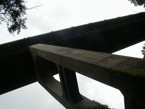 1994 Ford Probe - A concrete overpass structure is seen from a low angle, with trees visible on the right.