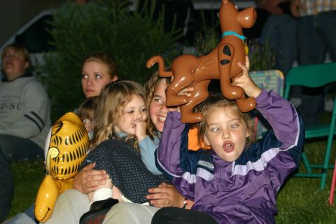 2003 Jeep TJ - Children enjoy inflatable toys at an outdoor event, with adults in the background.