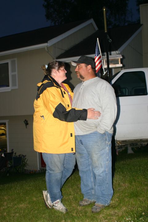 2003 Jeep TJ - A white van is partially visible in the background of a couple posing for a photo.