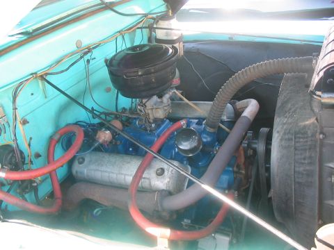 1986 Ford Bronco - Close-up view of the engine compartment, showing the engine block, air filter assembly, and cooling system components.