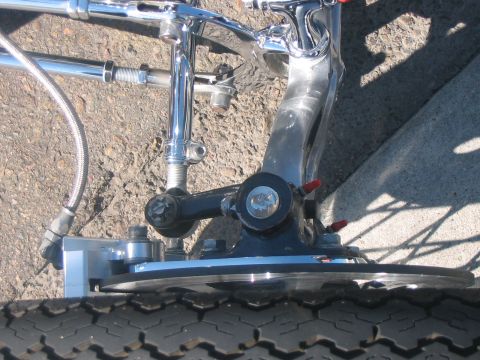 1986 Ford Bronco - Close-up view of a custom chrome steering linkage and disc brake assembly mounted on a tire.