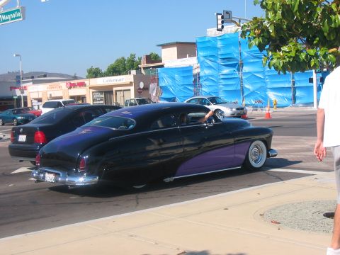 1986 Ford Bronco - A customized classic coupe with purple accents is parked on a street.