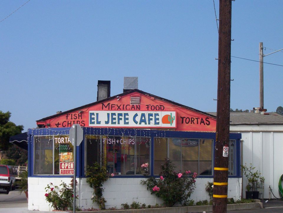 El Jefe Cafe building with signs for Mexican food, tortas, fish and chips. Open sign visible