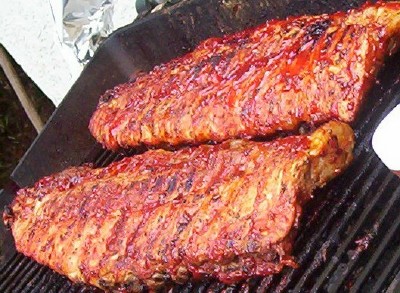 1995 Ford Bronco - Barbecued ribs cooking on a grill. Supermotors.net logo visible.