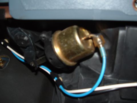 1989 Ford Bronco - Close-up view of an electrical connector with a brass housing and blue wire, likely a component from a vehicle's electrical system.
