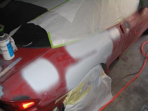 1994 Buick Park Avenue - Bodywork is underway on a vehicle, with primer and filler applied to the fender area.