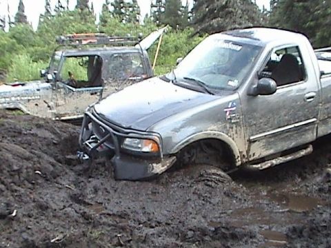 2000 Jeep Wrangler - Two off-road vehicles are stuck in thick mud after an outing.