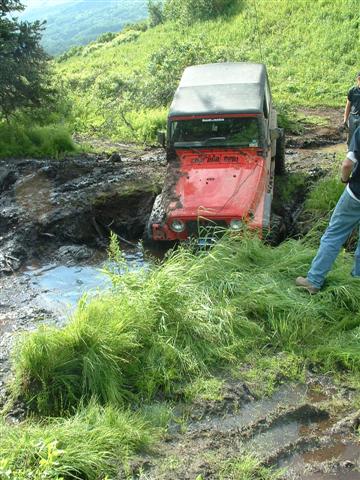 2000 Jeep Wrangler - Jeep TJ struggling through a muddy off-road trail.