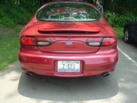 1993 Ford Taurus - This red sedan's taillights and body style do not match a 1993 Ford Taurus.